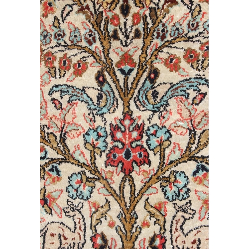 212A - A fine quality Persian Ghom silk tree of life rug, profusely decorated with deer and birds within th... 