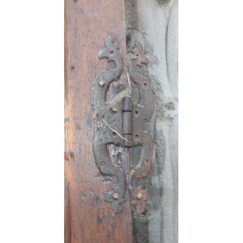 182 - An antique oak panel door with wrought iron hinges, approx 67cm x 196cm