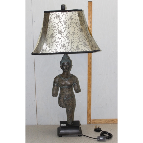 269B - A large table lamp and shade, the base formed as aN Oriental figure from antiquity, approx 96cm tall