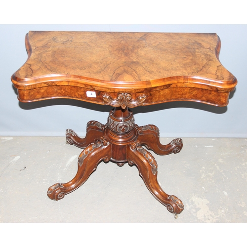 4 - A Victorian walnut fold over card table with baize line interior, with carved base and frieze, appro... 