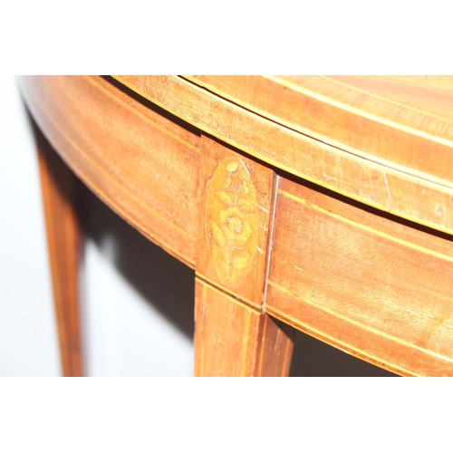 77 - A Georgian mahogany demi-lune card table with marquetry inlay, approx 90cm in diameter when open, ap... 