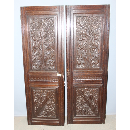 181 - A pair of antique carved oak doors, each approx 55cm wide x 166cm tall, by Edwards & Roberts