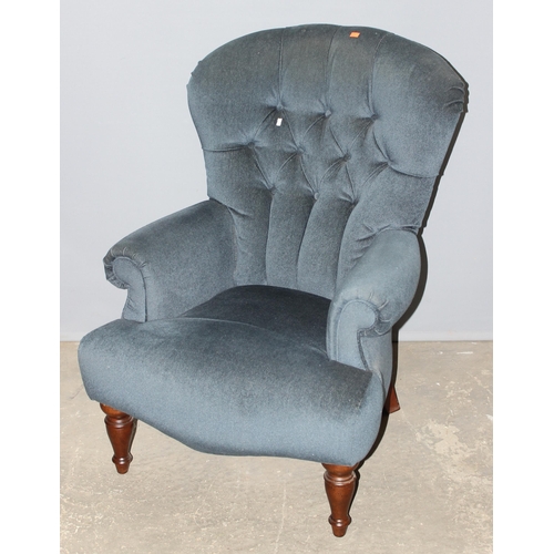 31 - A Victorian style blue button back armchair with turned legs