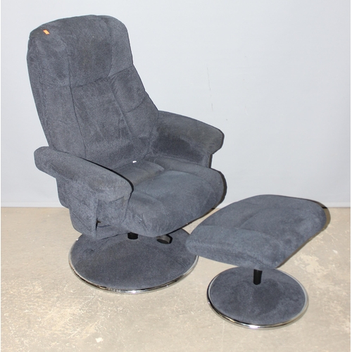 34 - A retro style blue fabric Lazyboy type armchair with footstool