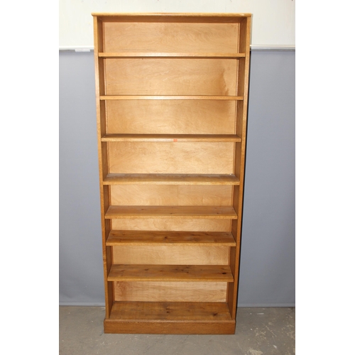 4 - A good quality modern light oak bookcase with adjustable shelves, approx 95cm wide x 25cm deep x 213... 