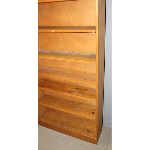 4 - A good quality modern light oak bookcase with adjustable shelves, approx 95cm wide x 25cm deep x 213... 