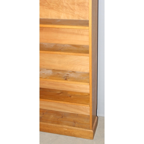 5 - A good quality modern light oak bookcase with adjustable shelves, approx 95cm wide x 25cm deep x 213... 