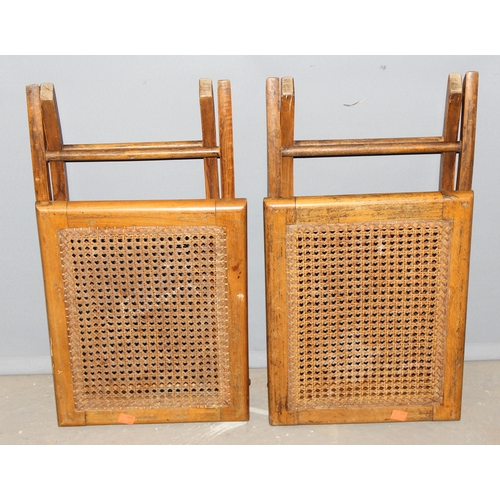 23 - A pair of early 20th century folding topped bergère campaign stools, approx 38cm wide x 30cm deep x ... 