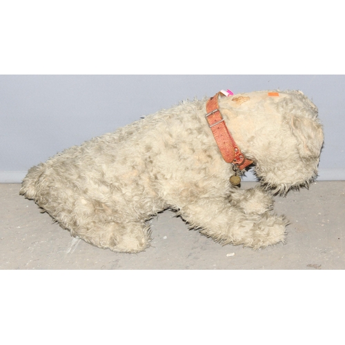 1507 - An early 20th century straw stuffed toy dog with a Tail Waggers Club collar tag, approx 73cm long