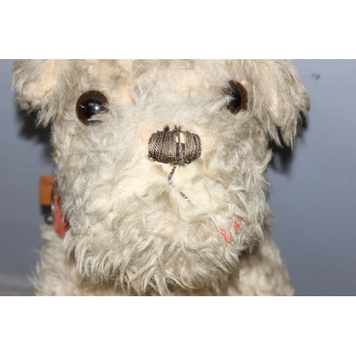 1507 - An early 20th century straw stuffed toy dog with a Tail Waggers Club collar tag, approx 73cm long