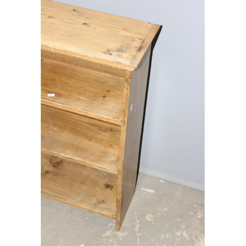 28 - A vintage or antique pine bookshelf, approx 129cm wide x 22cm deep x 77cm tall