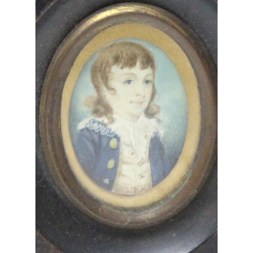 406 - A small antique portrait miniature of a young boy in Regency period dress, seemingly unsigned, in an... 