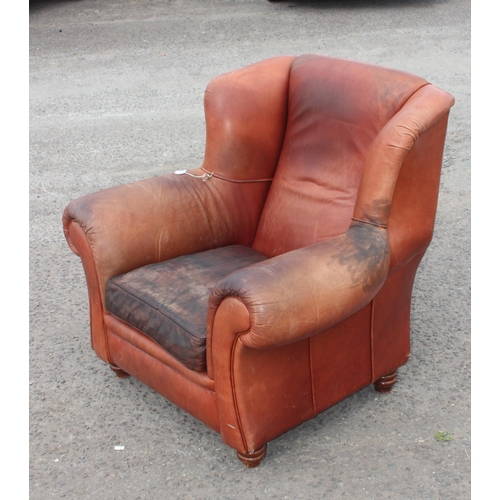 85 - A vintage brown leather club chair with turned wooden feet, approx 100cm wide