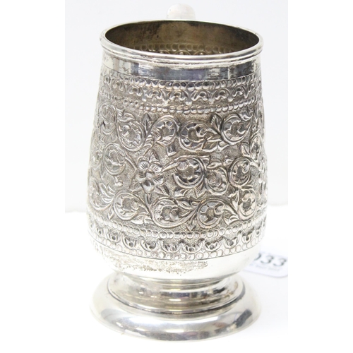 1033 - A large 19th century embossed silver pint tankard, likely Anglo-Indian, marked Sterling Silver to th... 