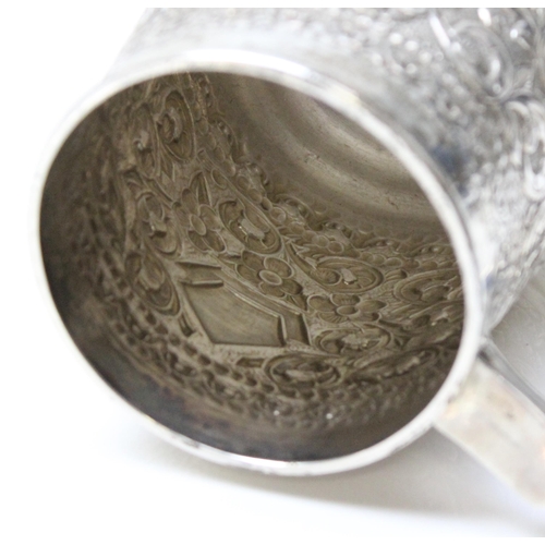 1033 - A large 19th century embossed silver pint tankard, likely Anglo-Indian, marked Sterling Silver to th... 