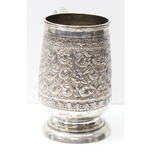 1034 - A large 19th century embossed silver pint tankard, likely Anglo-Indian, marked Sterling Silver to th... 