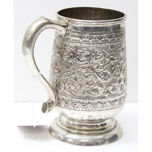 1034 - A large 19th century embossed silver pint tankard, likely Anglo-Indian, marked Sterling Silver to th... 