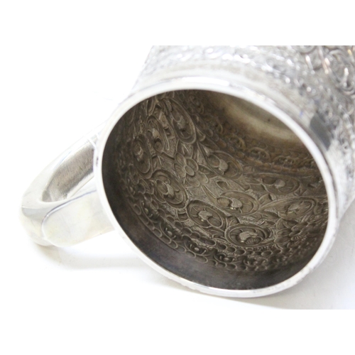 1034 - A large 19th century embossed silver pint tankard, likely Anglo-Indian, marked Sterling Silver to th... 