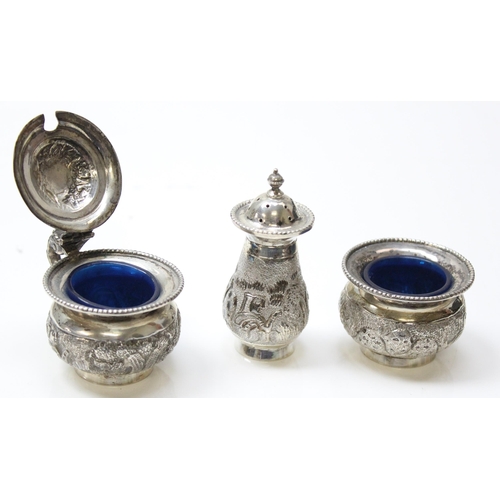 1036 - An Indian embossed silver 3 piece cruet set with blue liners and tray, all pieces marked Silver and ... 