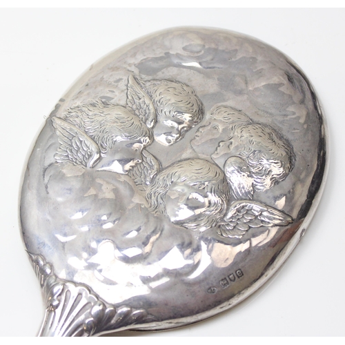 1037 - An antique silver hand mirror decorated with Reynold's Angels, London 1900 by William Comyns, approx... 