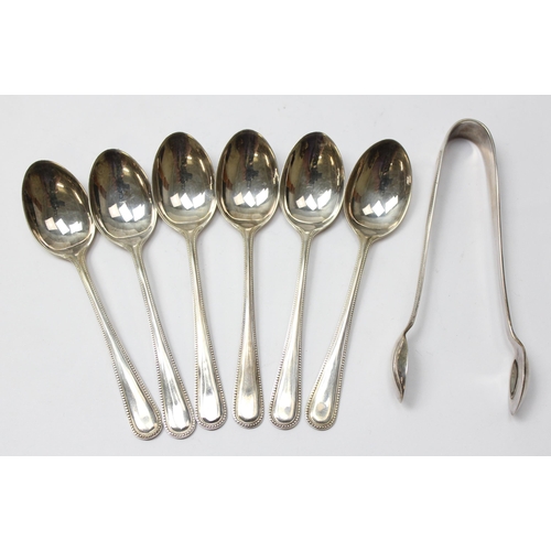 1059 - A boxed set of 6 silver teaspoons with sugar tongs, Birmingham 1933 by AC Bloxham, approx 93.69g gro... 