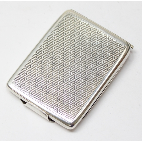 1061 - An Art Deco silver matchbook cover with engine turned decoration, Birmingham 1928, approx 30.21g gro... 