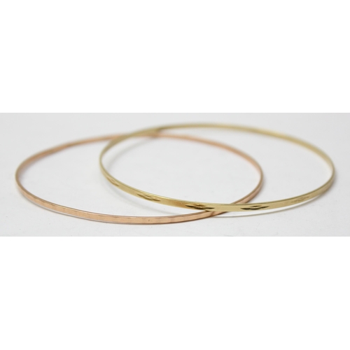 1103 - A pair of 14ct gold bangles, marked 585 and XRF confirmed, approx 7.61g gross