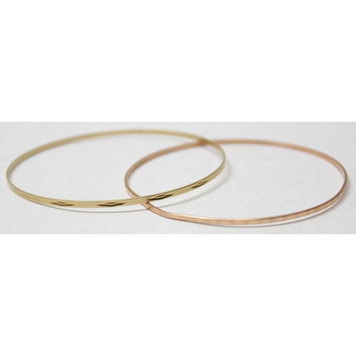 1103 - A pair of 14ct gold bangles, marked 585 and XRF confirmed, approx 7.61g gross