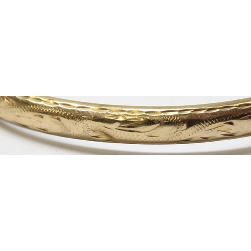 1104 - 9ct gold cuff bangle with engraved decoration, Birmingham 1964, approx 8.41g gross