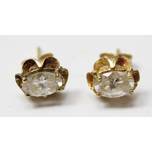 1105 - A pair of 9ct gold mounted white stone stud earrings, marked and XRF tested, approx 0.99g gross