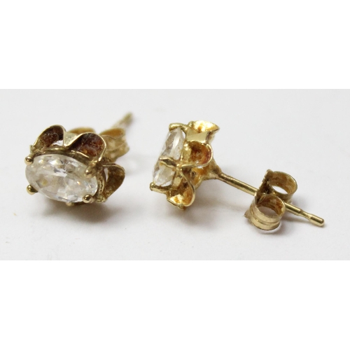 1105 - A pair of 9ct gold mounted white stone stud earrings, marked and XRF tested, approx 0.99g gross