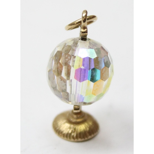 1106 - A 9ct gold mounted charm formed as a facet cut crystal globe, approx 3.83g gross