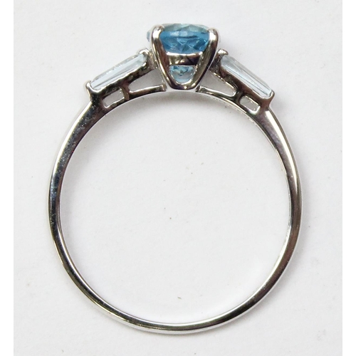 1116 - 9ct white gold ring set with a central blue stone, likely a Topaz and flanked by 2 baguette cut whit... 