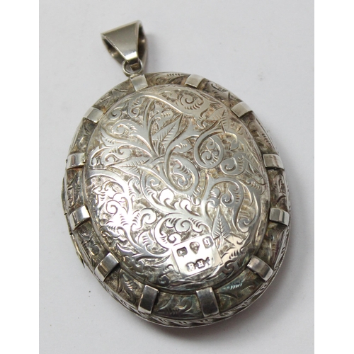 1122 - A Victorian silver locket with extensive engraved decoration, Chester 1879, approx 48mm x 40mm, appr... 