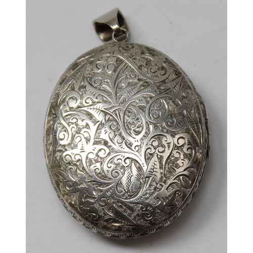 1122 - A Victorian silver locket with extensive engraved decoration, Chester 1879, approx 48mm x 40mm, appr... 