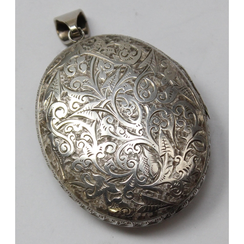 1122 - A Victorian silver locket with extensive engraved decoration, Chester 1879, approx 48mm x 40mm, appr... 