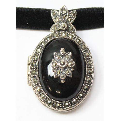 1123 - A Victorian style black enamel and silver marcasite locket, in box, approx 35mm tall