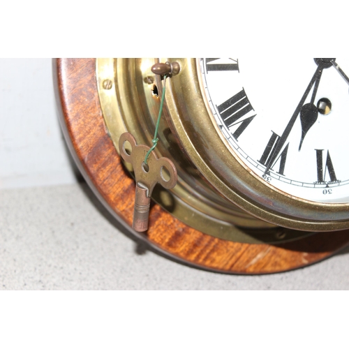 1325 - Vintage brass cased bulk head style mechanical movement wall clock and a similar brass cased bulk he... 