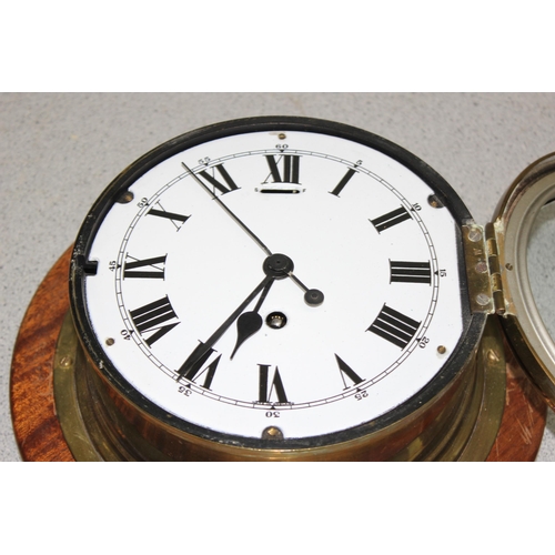 1325 - Vintage brass cased bulk head style mechanical movement wall clock and a similar brass cased bulk he... 