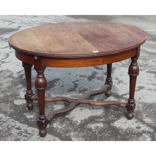 125 - An antique French oval table with extending leaf, approx 122cm wide