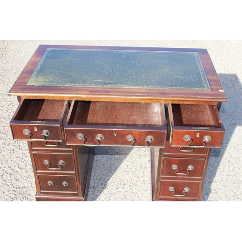 156 - A small vintage leather topped pedestal desk with drop handles, approx 93cm wide x 53cm deep x 78cm ... 