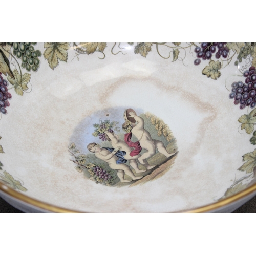 1663 - An impressive 19th century pottery punchbowl, likely by Prattware with grape and vine leaf border to... 