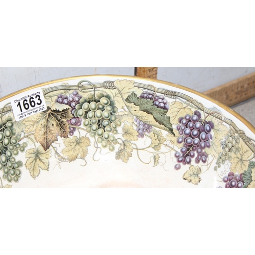 1663 - An impressive 19th century pottery punchbowl, likely by Prattware with grape and vine leaf border to... 