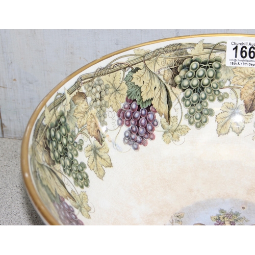 1663 - An impressive 19th century pottery punchbowl, likely by Prattware with grape and vine leaf border to... 