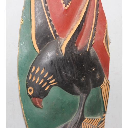 1830 - An African carved wooden shield and a short metal ended spear (2)