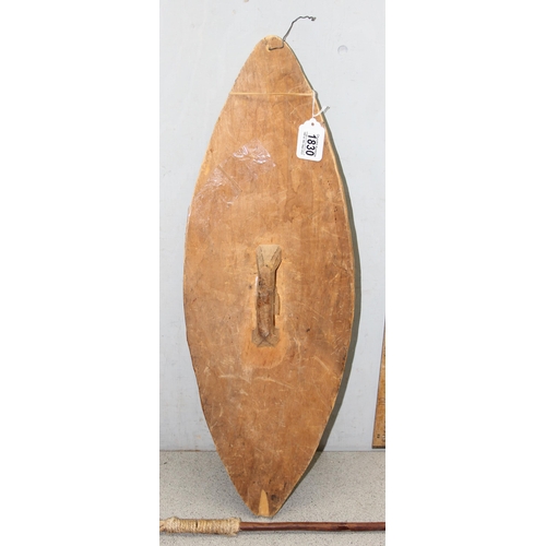 1830 - An African carved wooden shield and a short metal ended spear (2)