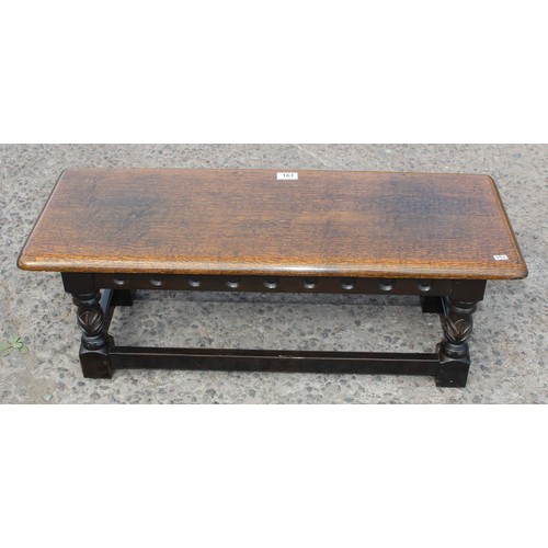 161 - A small vintage oak stool or foot rest, approx 83cm wide