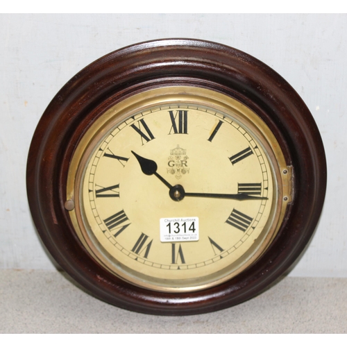 1314 - Circular mahogany cased  8 inch dial mechanical winding wall clock - with key