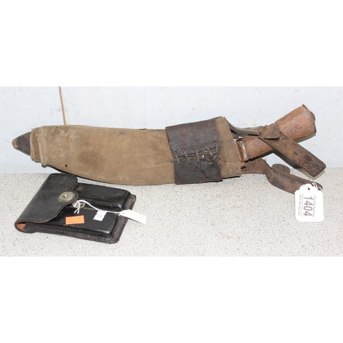 1404 - A vintage Kukri knife in sheath, seemingly unmarked and a 1951 dated leather US Police magazine hold... 