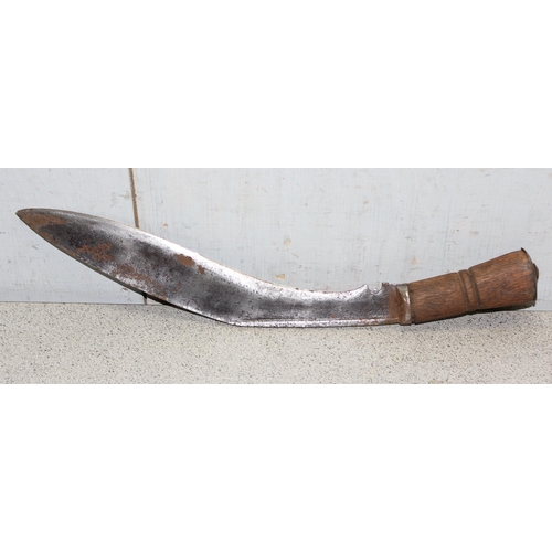 1404 - A vintage Kukri knife in sheath, seemingly unmarked and a 1951 dated leather US Police magazine hold... 